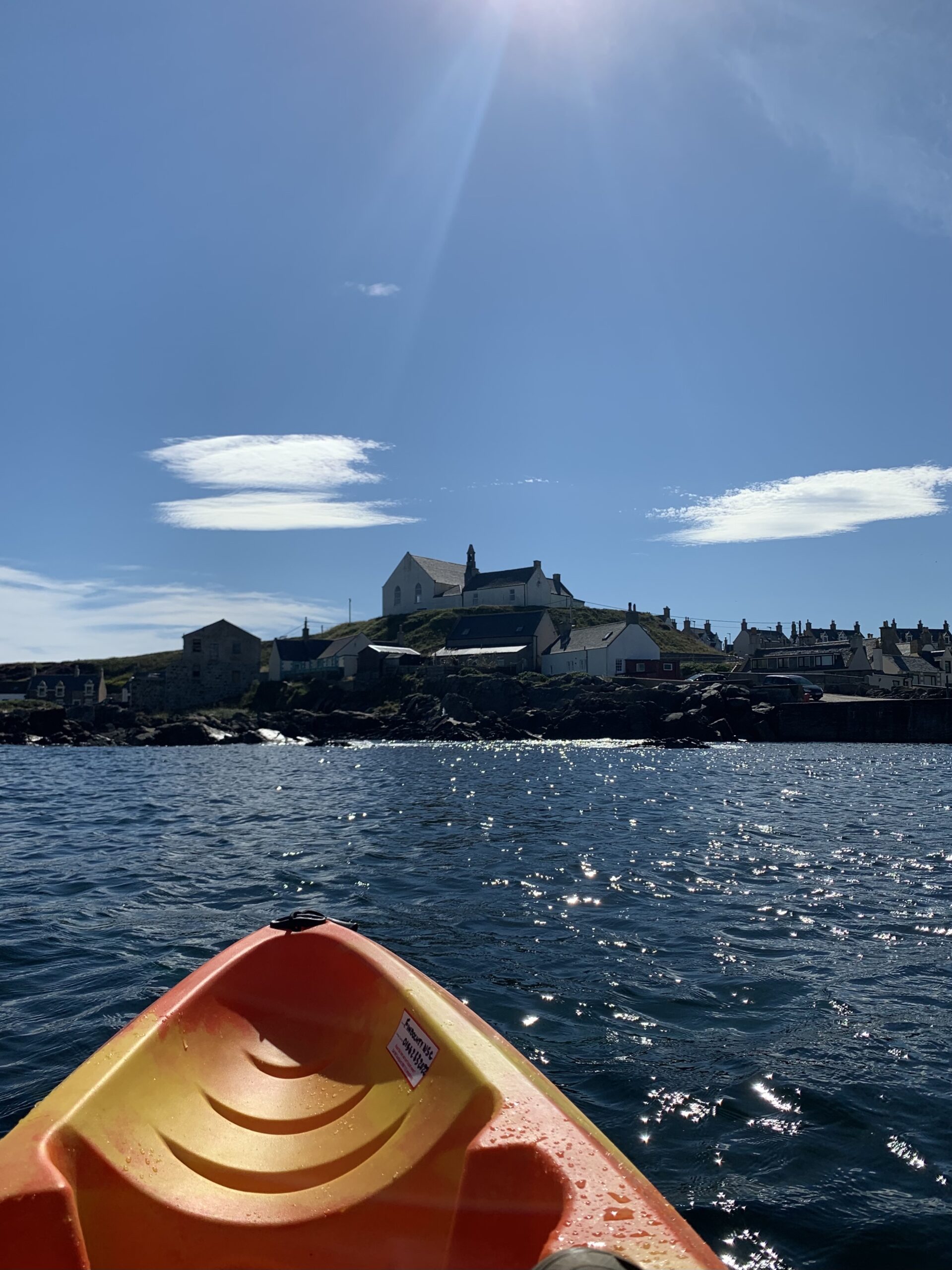 Sea kayak on the water in front of Findochty Church of Scotland